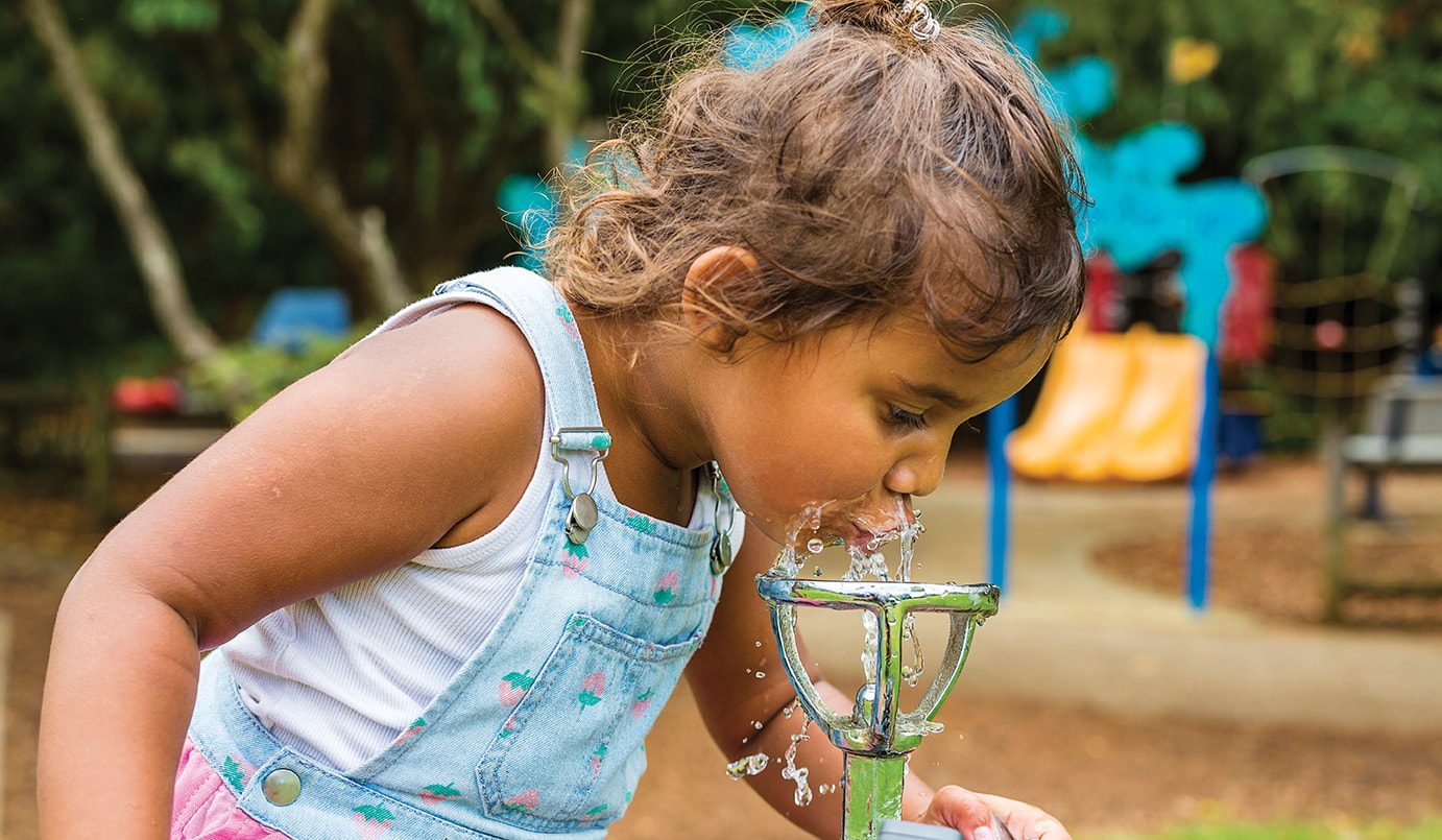 Girl drinking from water fountain