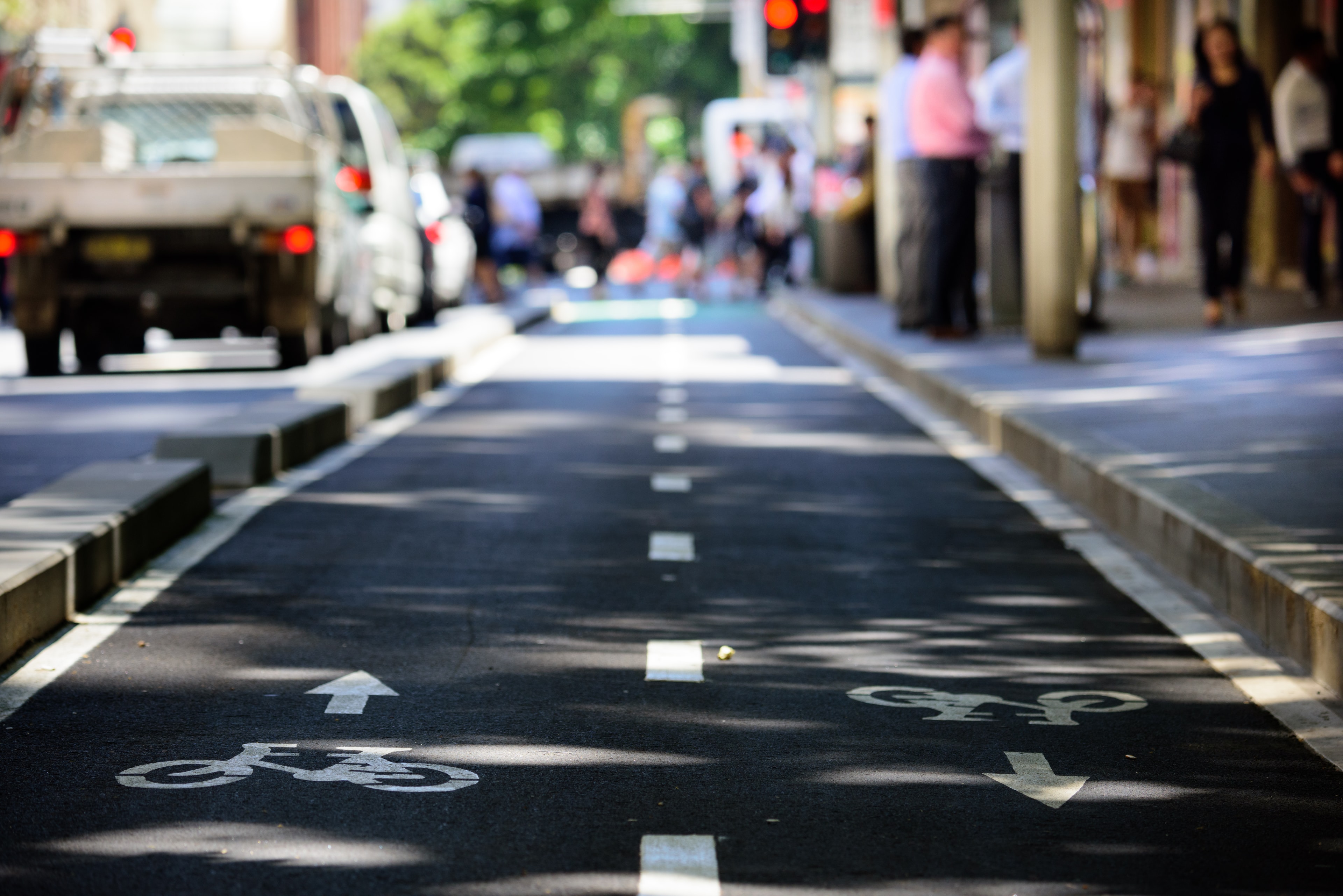 Separated bike path with cars in background